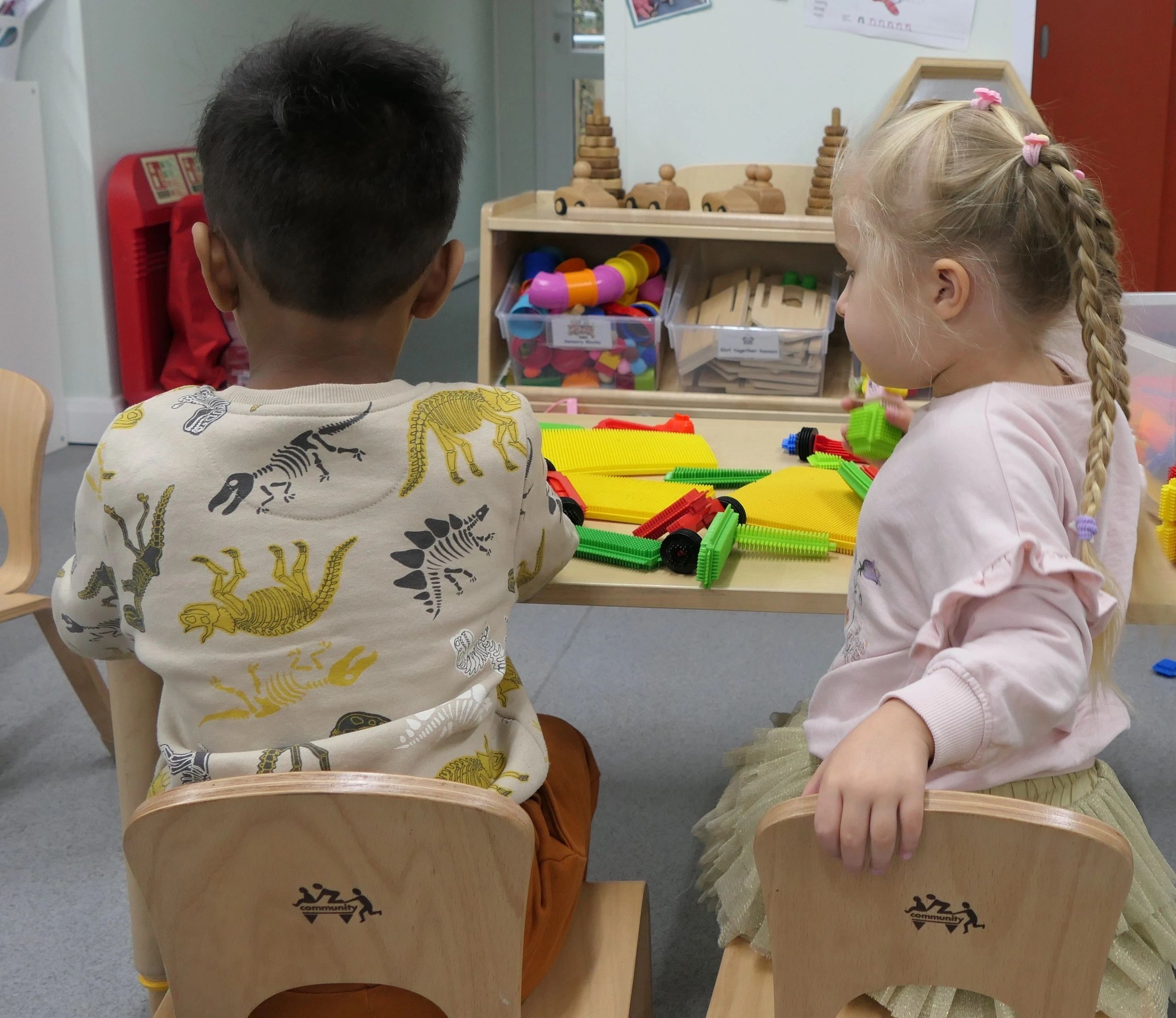 Nursery worker providing inclusive care for a child